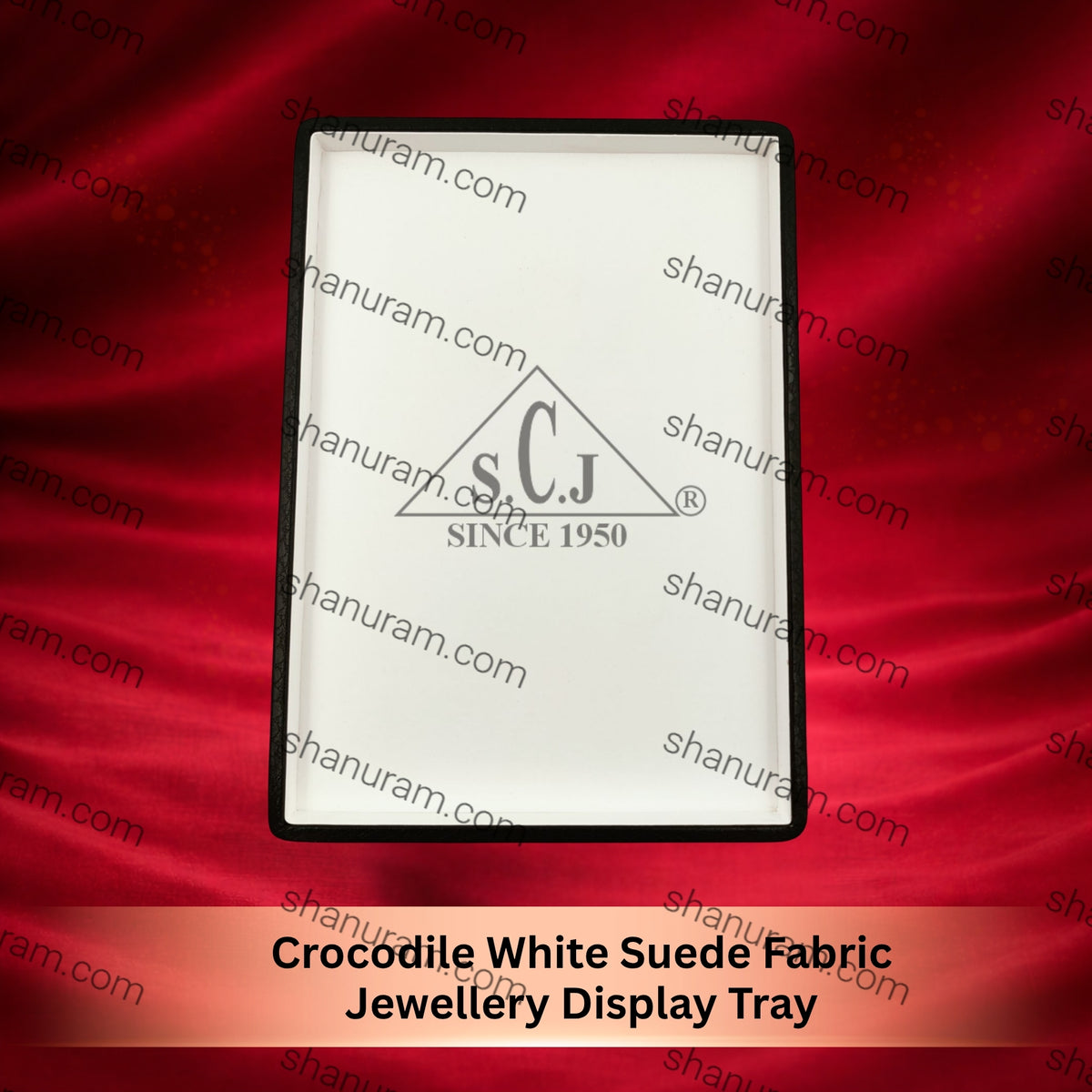 Jewellery display tray with 's.C.j.' logo on a red fabric background