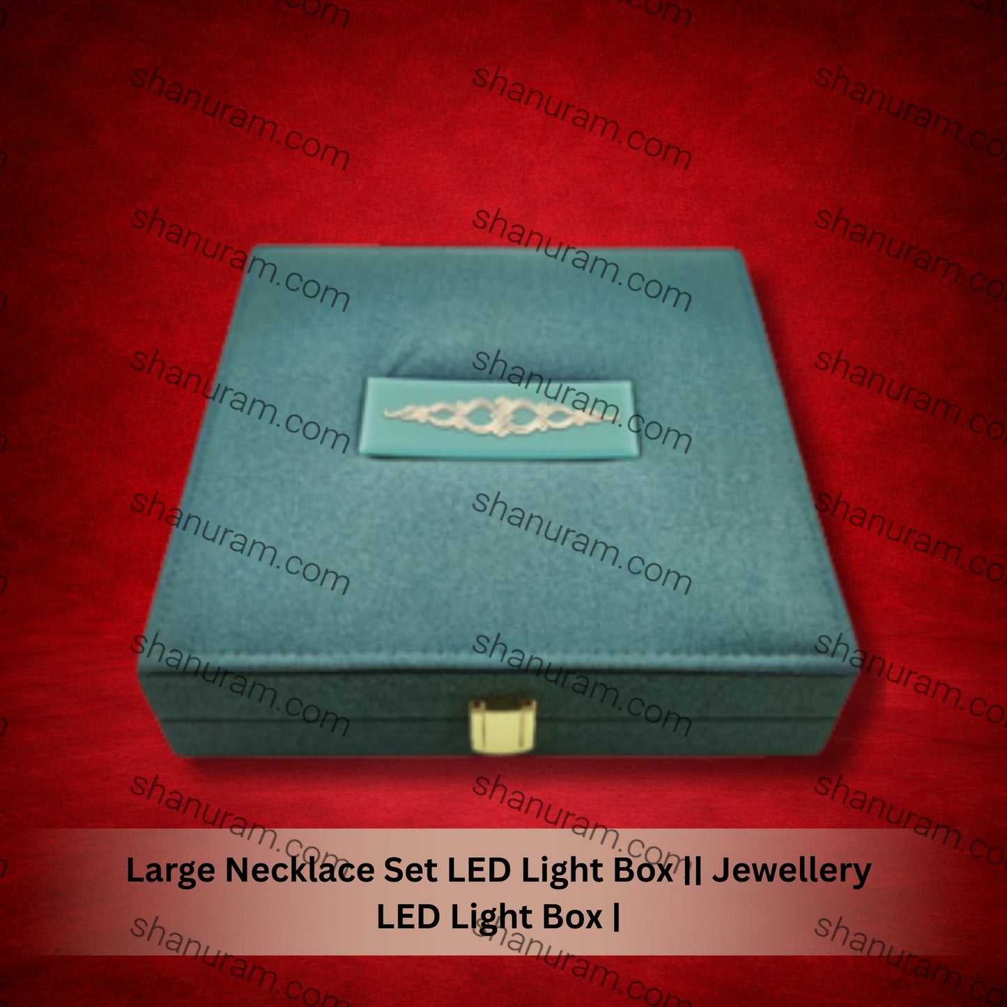 Teal jewelry box with a gold necklace on a red background