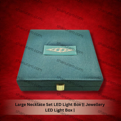 Teal jewelry box with a gold necklace on a red background