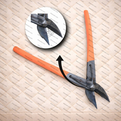 Orange and black archery broadhead on a textured surface with a close-up inset.
