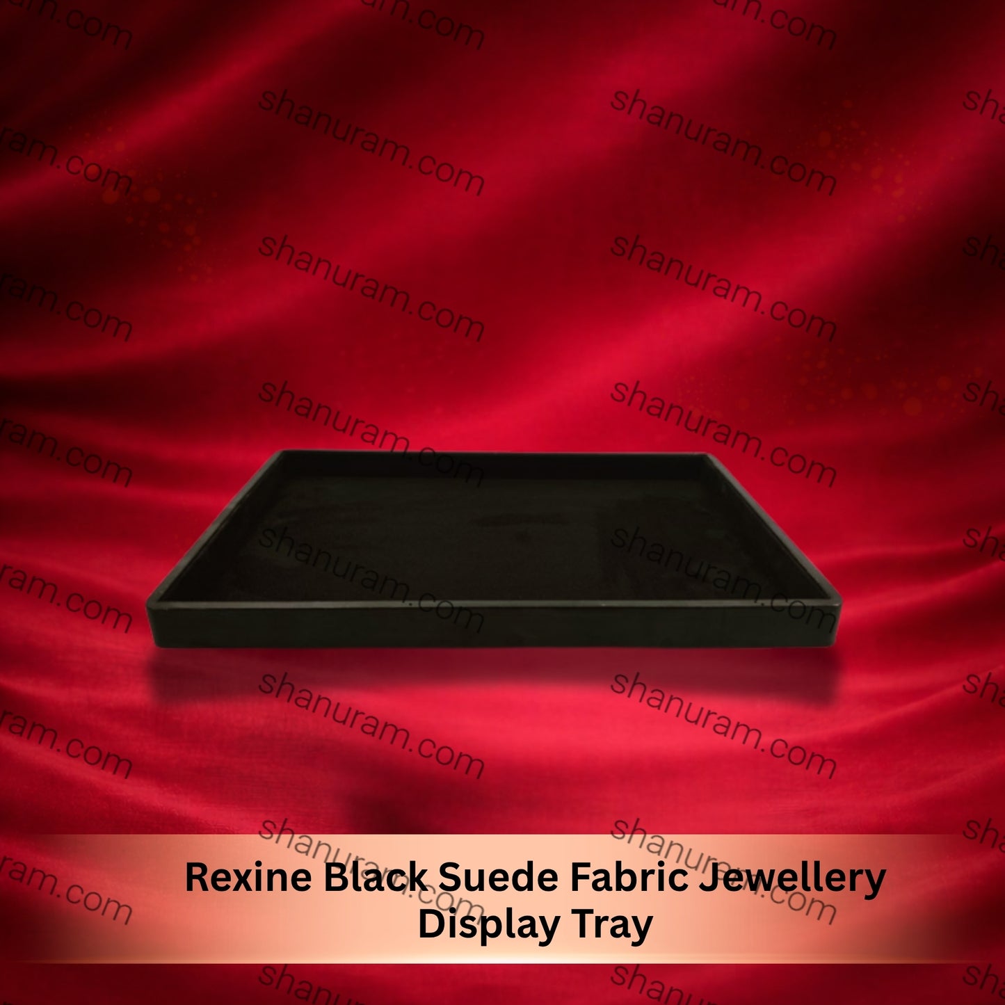 Black suede fabric jewelry display tray on a red satin background with 'shapuram.com' branding.