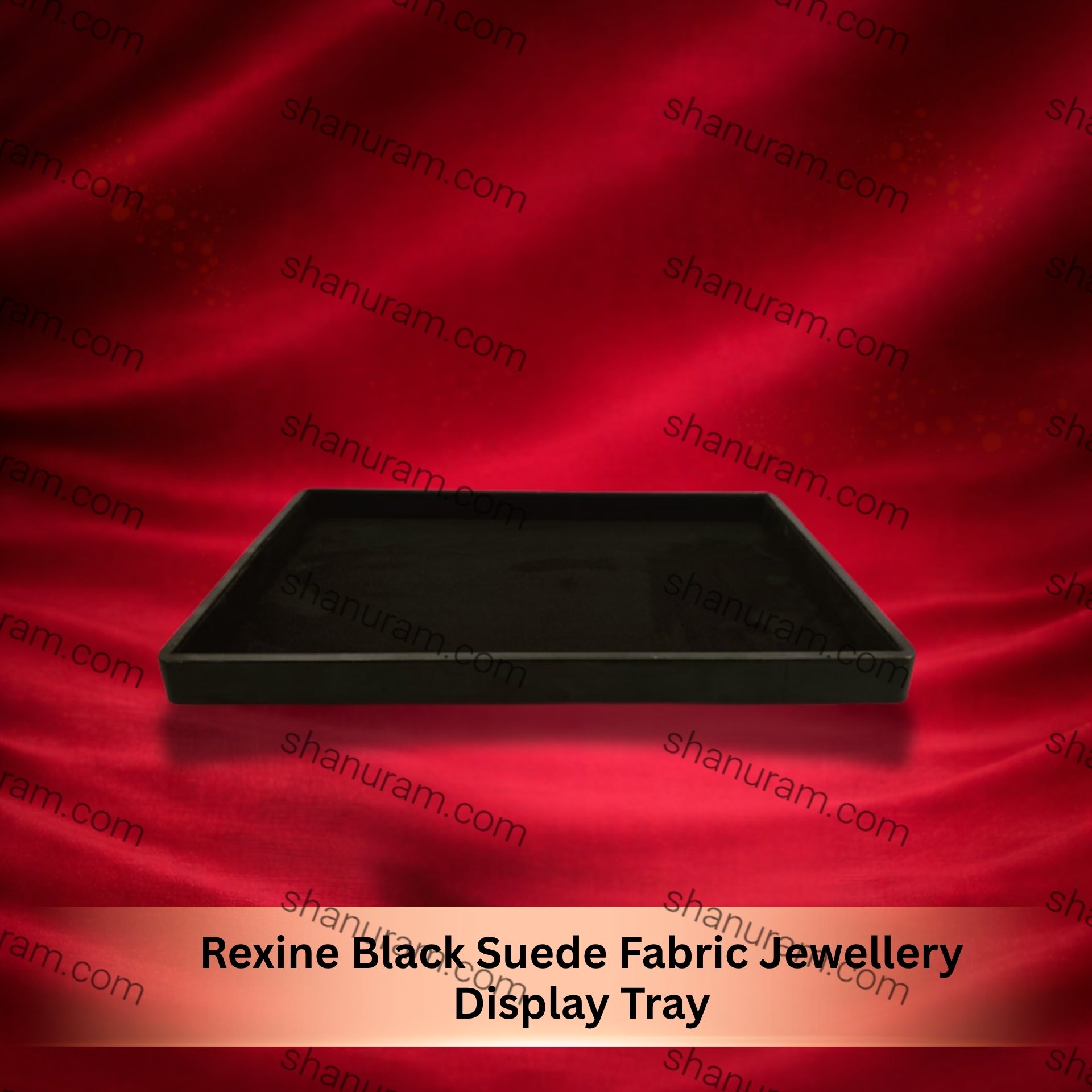 Black suede fabric jewelry display tray on a red satin background with 'shapuram.com' branding.