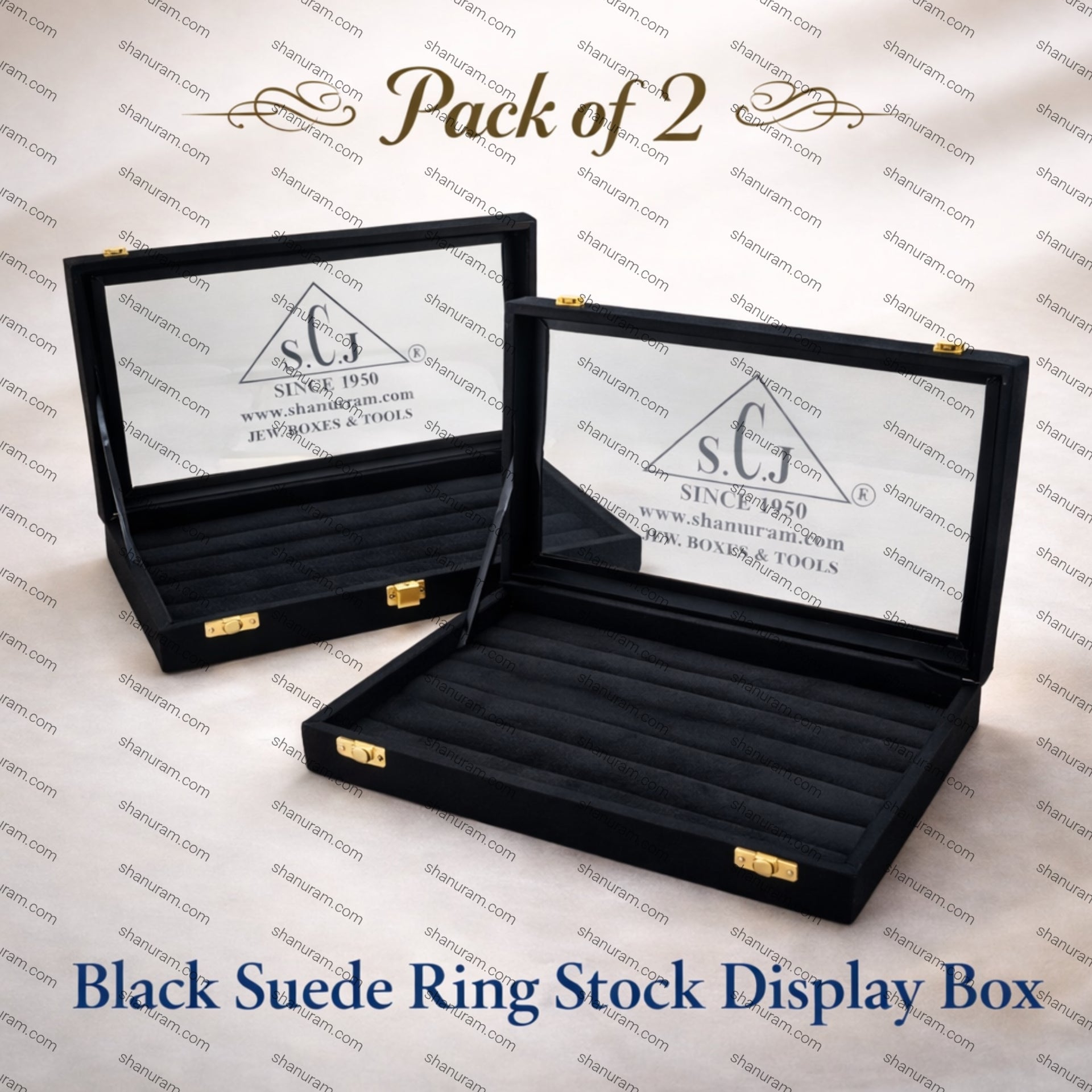 Two black suede ring stock display boxes with visible branding on a branded background.