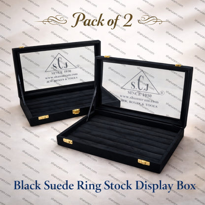 Two black suede ring stock display boxes with visible branding on a branded background.