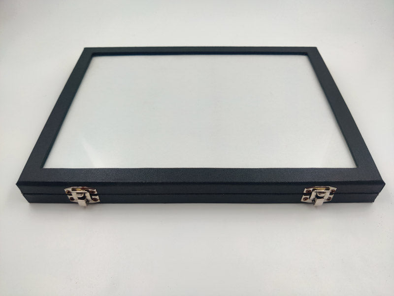 A black rexine material gemstone glass display storage box with a clear glass lid on top.