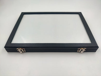 A black rexine material gemstone glass display storage box with a clear glass lid on top.